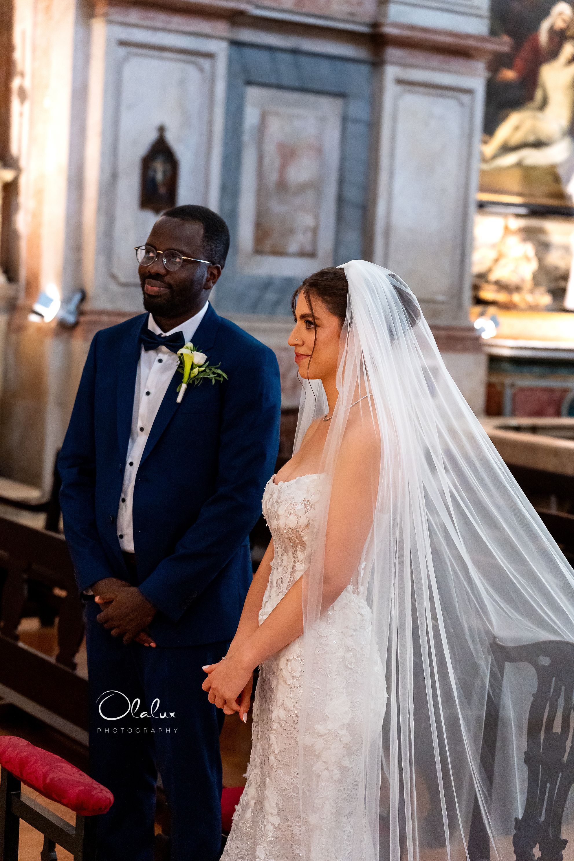 Angela at the altar, veil falling
