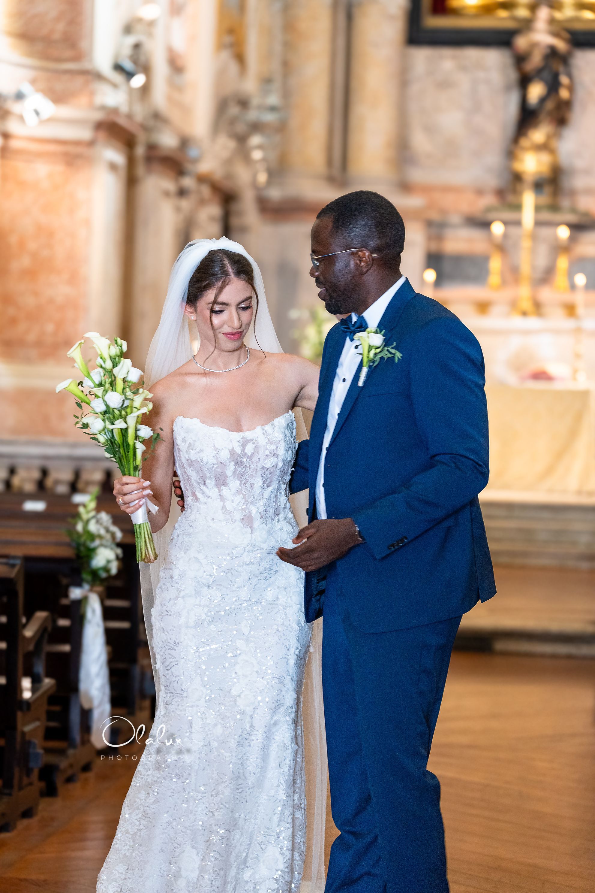 Angela and Femi walking the church aisle