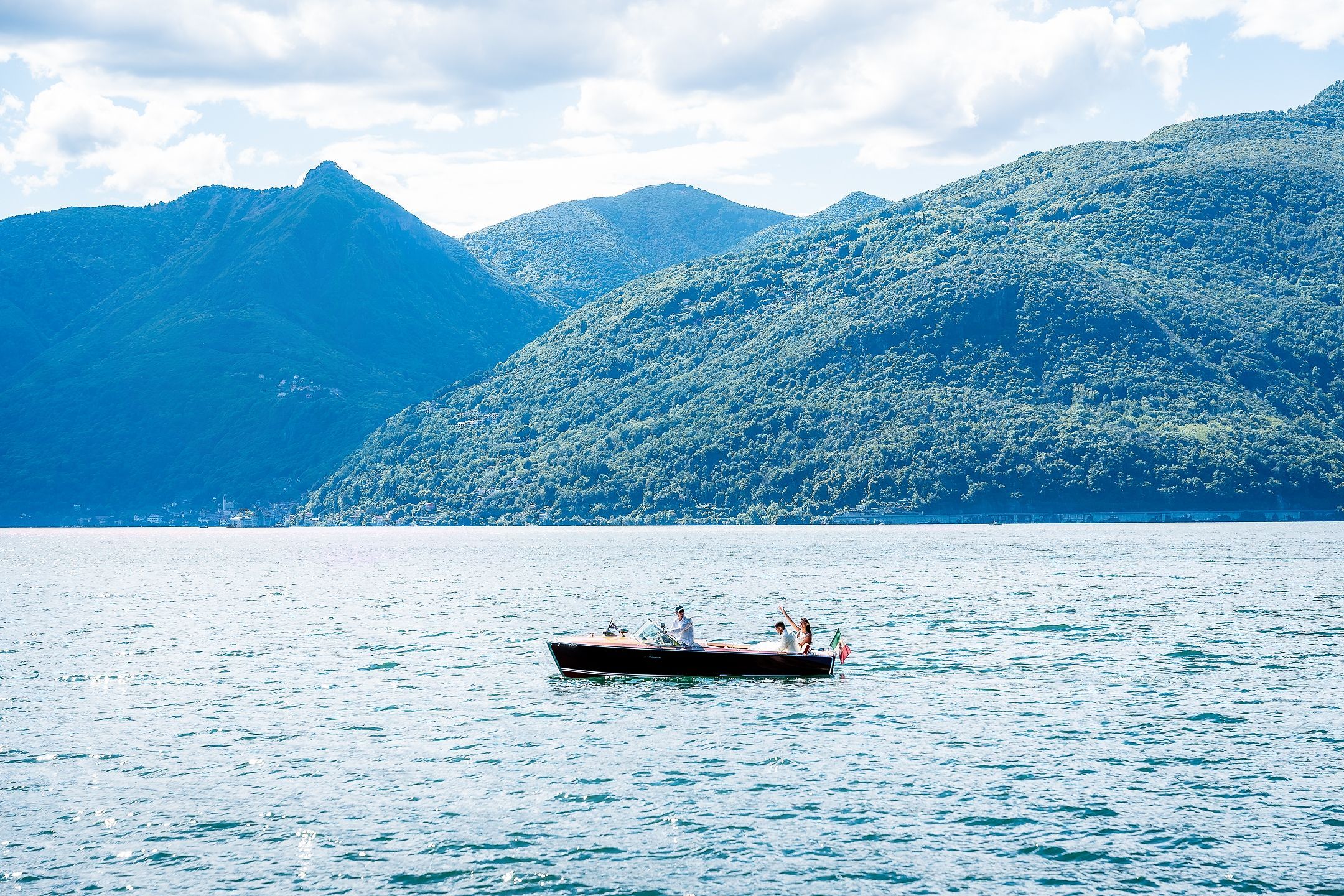 A wooden boat on the lake beneath the mountains